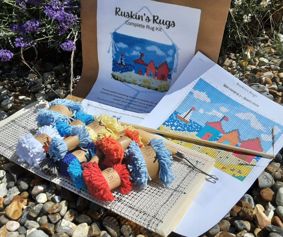 A Ruskin's Rug kit including string, a wooden tool and a diagram showing how the finished product should look.