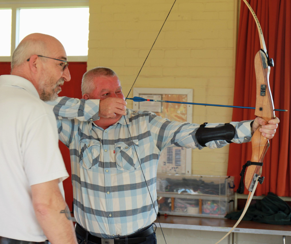 Vision impaired archer Jason Beasley is guided by Archery GB coach Andy Beer